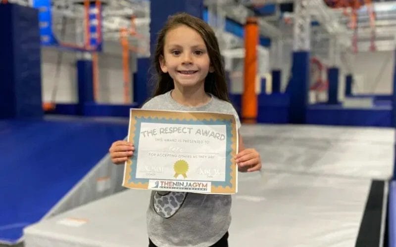 Girl showing diploma at The Ninja Gym